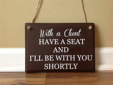 With A Client Have A Seat And Ill Be With You Shortly Office Sign