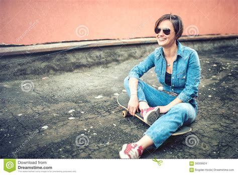Urban And Modern Lifestyle Hipster Smiling Girl With Skateboard Wearing Jeans Sunglasses Stock