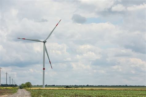 Modern Wind Turbine In Field On Day Alternative Energy Source Stock