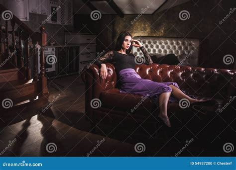 Beautiful Woman Sitting On A Leather Vintage Sofa Stock Photo Image