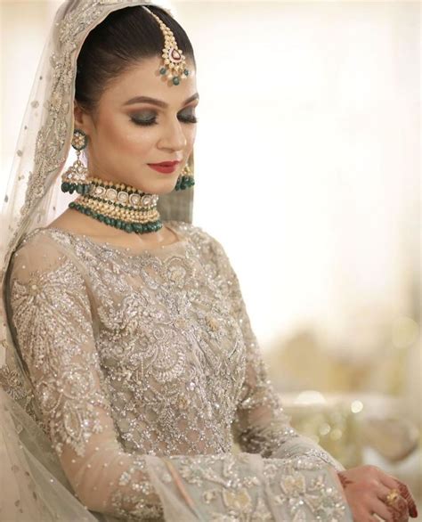 a woman in a bridal gown and jewelry
