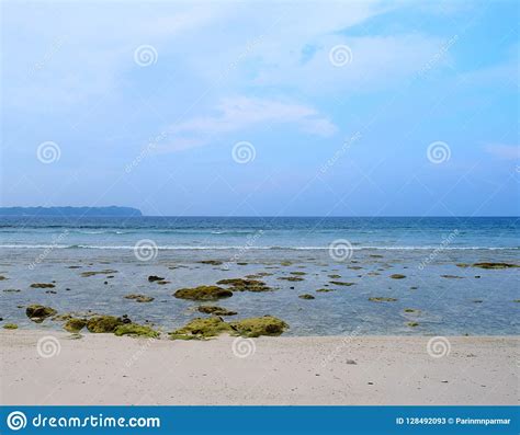 Azure Clean Sea Water At Rocky Beach And Blue Sky Natural Background