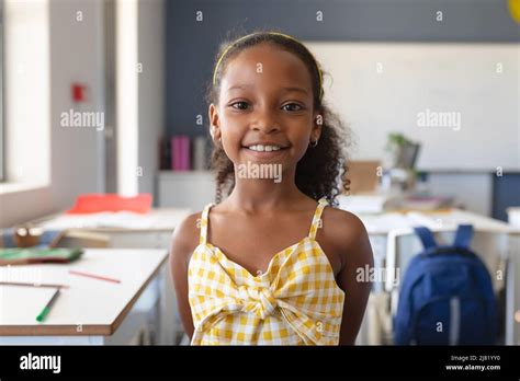 Portrait Of Smiling African American Elementary Schoolgirl Standing In