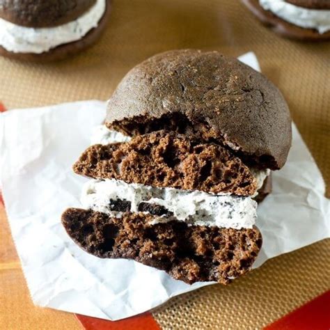 There Is A Chocolate Sandwich With White Frosting On The Top And Two