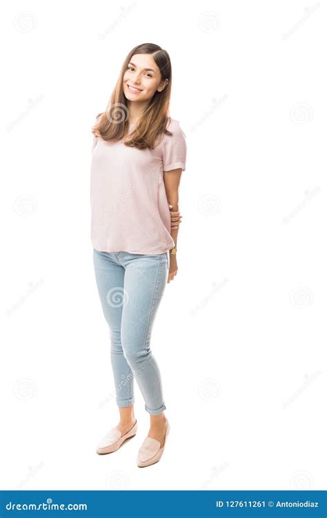 Happy Female With Hands Behind Back Over Plain Background Stock Image