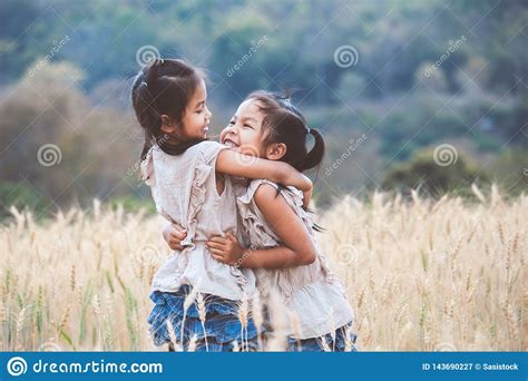 Two Asian Child Girls Hugging Each Other And Playing