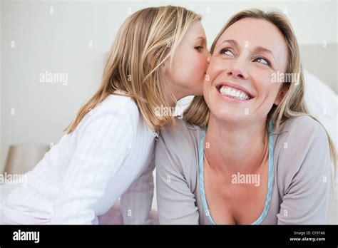 Girl Giving Her Mother A Kiss Stock Photo Alamy