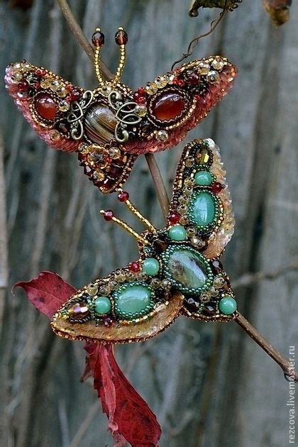 Two Brooches Are Sitting On Top Of A Branch