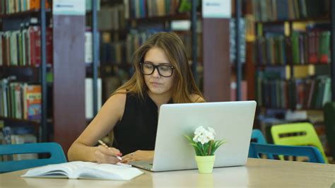 Girl Student Working At A Computer In The Library Stock Video Footage