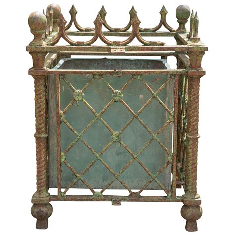A traveler through the twentieth century, this stone trou. Pair of Cast Iron Versailles Planters at 1stdibs