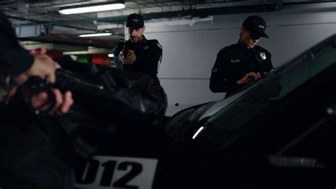 Police Team Arresting Criminal At Underground Parking Male Cop