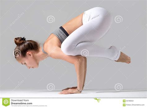 Download bakasana images and photos. Young Woman In Bakasana Pose, Grey Studio Background Stock ...
