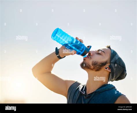 It Fuels A Better Workout A Sporty Young Man Drinking Water While