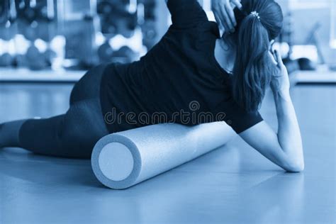 Woman Doing Foam Roller Exercise On A Floor In Gym Stock Photo Image