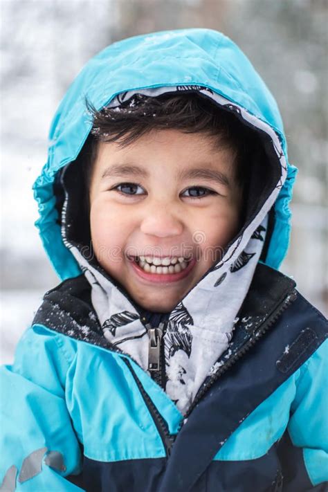 Winter Fun Portrait Of A Happy Boy Dressed For Winter And Playing In