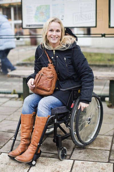 Portrait Of Happy Disabled Woman In Wheelchair At Bus Stop Stock