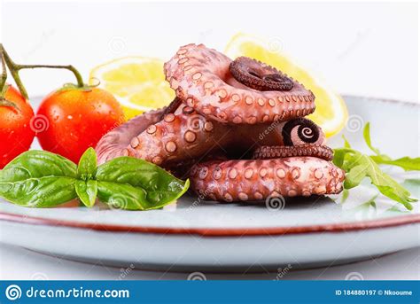 Close Up Of Raw Octopusraw Octopus Tentacles In A Blue Plate With