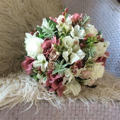 A Bridal Bouquet Featuring Artificial Silk Dusky Pink And Ivory Flowers