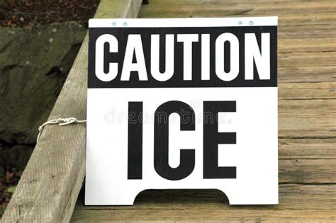 Closeup Of A Caution Ice Sign On The Wooden Bridge Stock Image