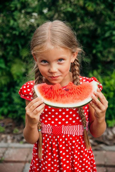 Little Girl In Red Dress Eating Watermelon In The Garden Kids Eat