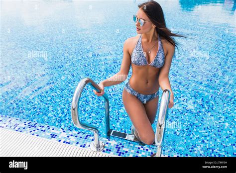 Beautiful Woman Entering Swimming Pool In Bikini Stock Photo Alamy
