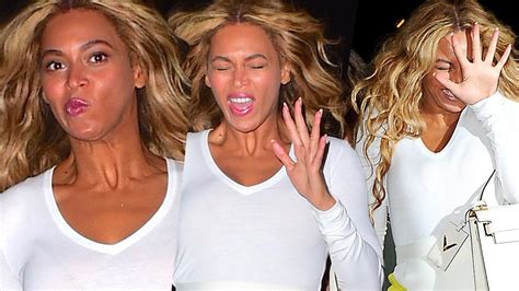 beyoncé looks shocked by camera flashes and flaunts her on the run macbook case while leaving