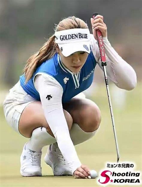 A Woman Kneeling Down Holding A Golf Club