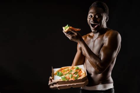 Premium Photo Black Handsome Naked Man Eats A Pizza Safety Food Delivery For People Who Stays