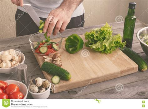 Man Prepares A Salad Of Fresh Vegetables Stock Photo Image Of Person