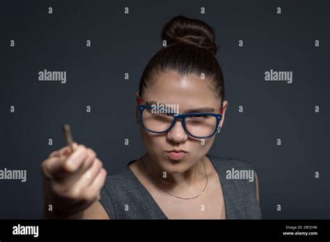 Close Up Portrait Of A Brunette Girl Strict Teacher In Glasses Looking At The Camera Pointing
