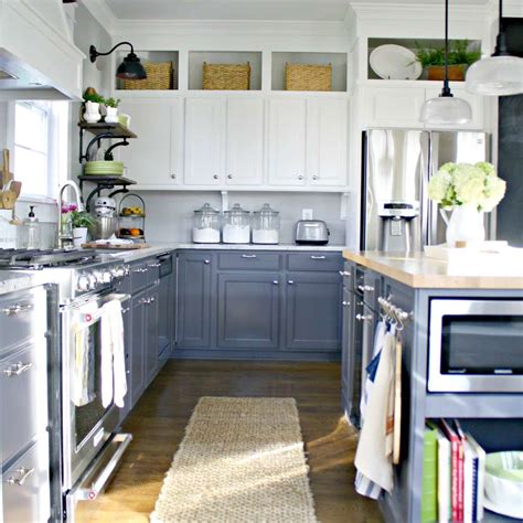 We love how a brick wall separates the space and allows you to keep the space above the cabinets empty while still adding drama. 9 Ways to Decorate Above Your Kitchen Cabinets