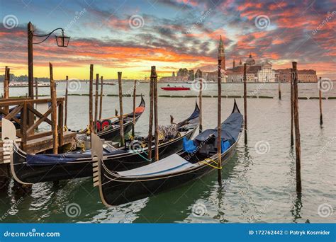 Venetian Gondolas At The Harbor And San Giorgio Maggiore Island At