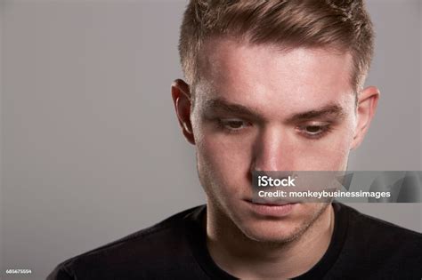 Young White Man Looking Down Head And Shoulders Stock Photo Download