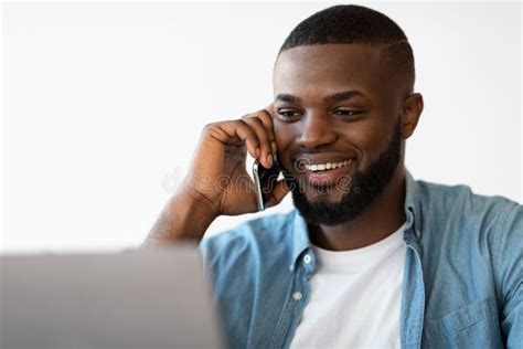 Closeup Portrait Of Smiling Black Man Talking On Cellphone And Using