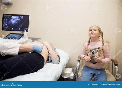 Gynecologist Does Cardiotocography Of The Fetus A Young Doctor