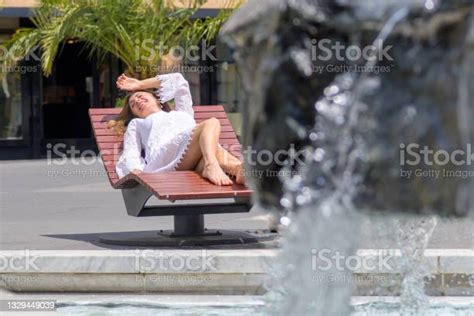 Woman Enjoying A Relaxing Day Sunbathing On A Recliner Stock Photo