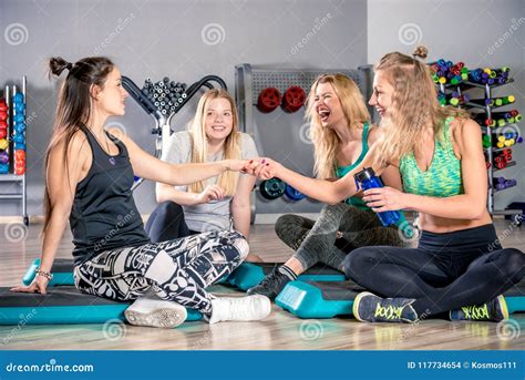 Four Friends After A Workout In The Gym Talking Stock Photo Image Of