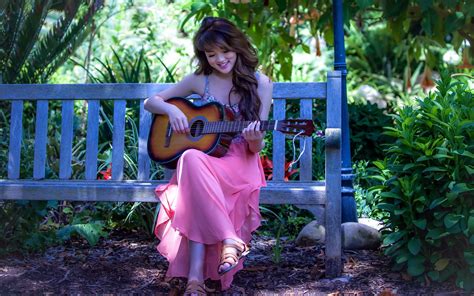 Check spelling or type a new query. A girl sits on a bench in the garden and playing guitar ...