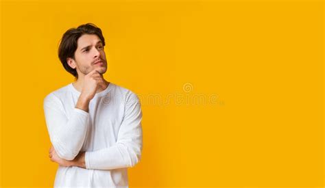 Doubtful Man Thinking About Something Touching Chin With Thoughtful