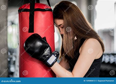 Attractive Female Boxer Training With Kick Boxing At Gym With