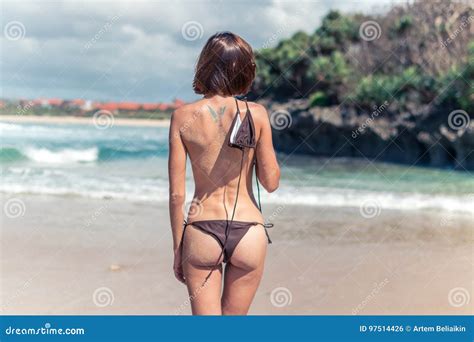 Young Woman Without Bra On The Tropical Beach Of Bali Island Bikini