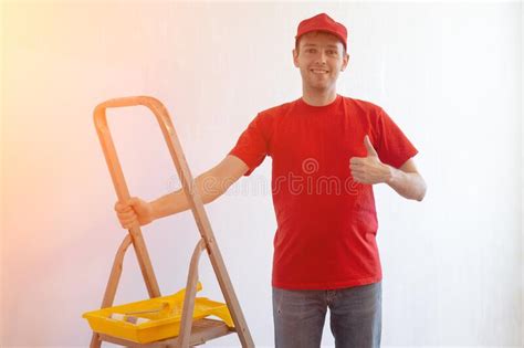 Young Professional Repair Man Showing Thumbs Up Gesture On Ladder And