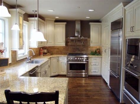 For those looking for a traditional style kitchen, the color cream is used to convey a warmness and elegance that many homeowners love. love the dark gray walls with the cream cabinets | Home, Sweet home, Ivory cabinets