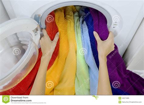 Woman Taking Color Clothes From Washing Machine Stock