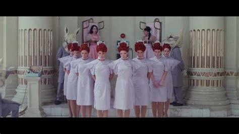 A Group Of Women Standing Next To Each Other In Front Of A Building With Red Hair