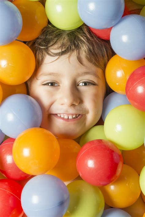 Portrait Of A Boy With His Face Surrounded By Colored Balls Stock Photo Image Of Face Color