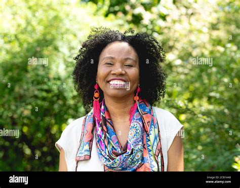 Portrait Of A Laughing Dark Skinned Woman With Curly Hair And