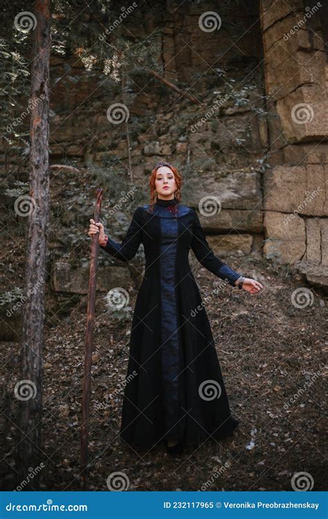 Evil Witch With A Staff In The Forest Slavic Witch Creates Red Magic