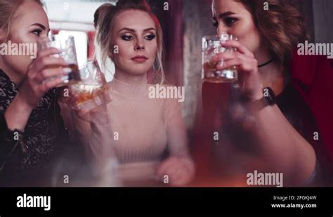 Three Pretty Girls Having A Conversation Laughing And Drinking Alcohol Stock Video Footage Alamy