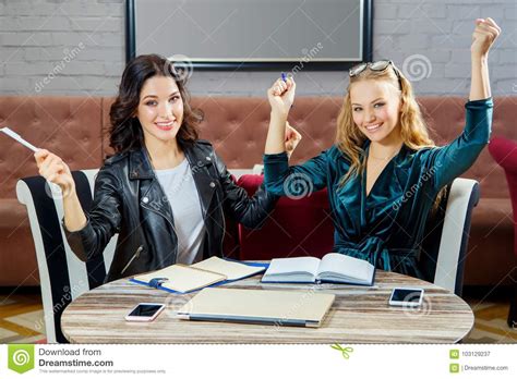 Two Women Are Discussing A Business Project In A Restaurant Stock
